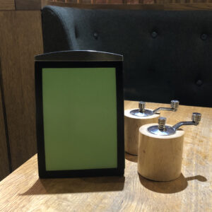 A6 black magnetic menu holder in situ at a restaurant at London Gatwick
